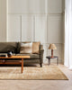 A stylish living room in warm browns and earthy greens, styled by Baya Living. 