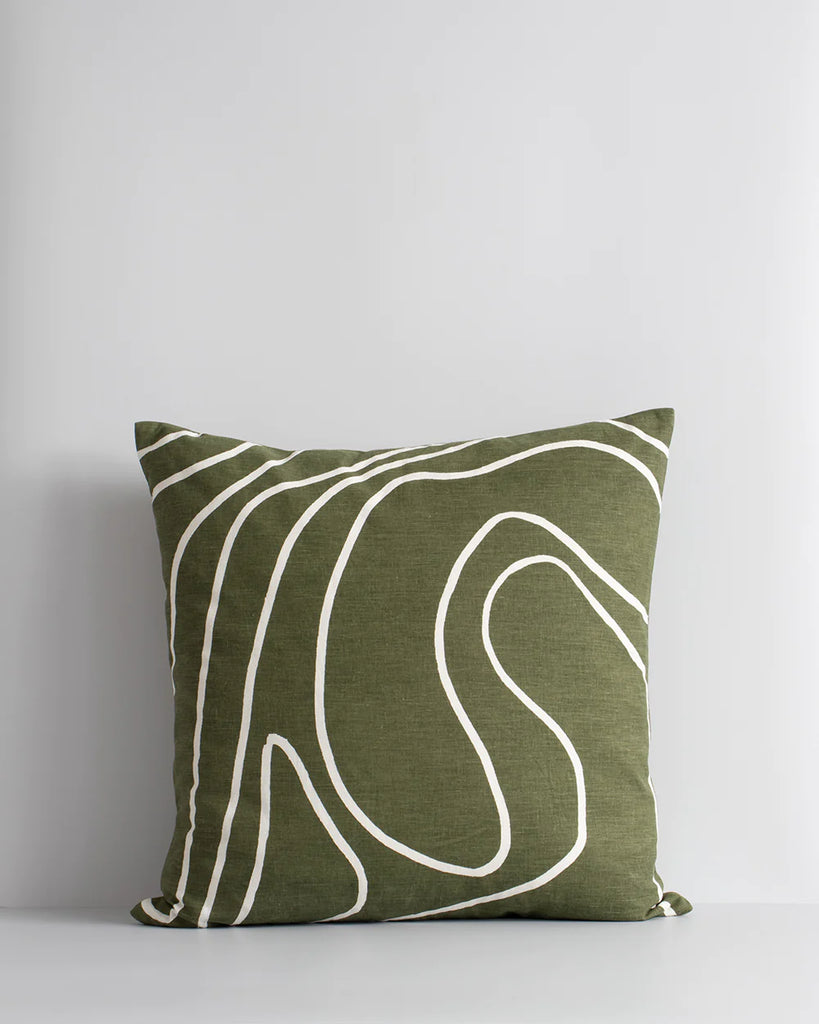 Baya Picchu cushion featuring swirling white lines on an olive green base