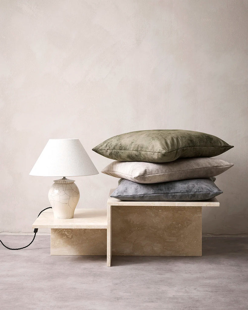 Pile of velvet Baya cushions in a contemporary home