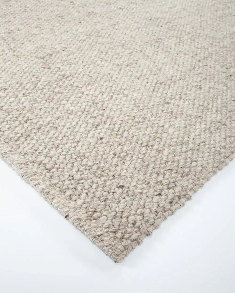 Corner of the Baya woven textural floor rug 'Omaha' in colour 'Pebble' 