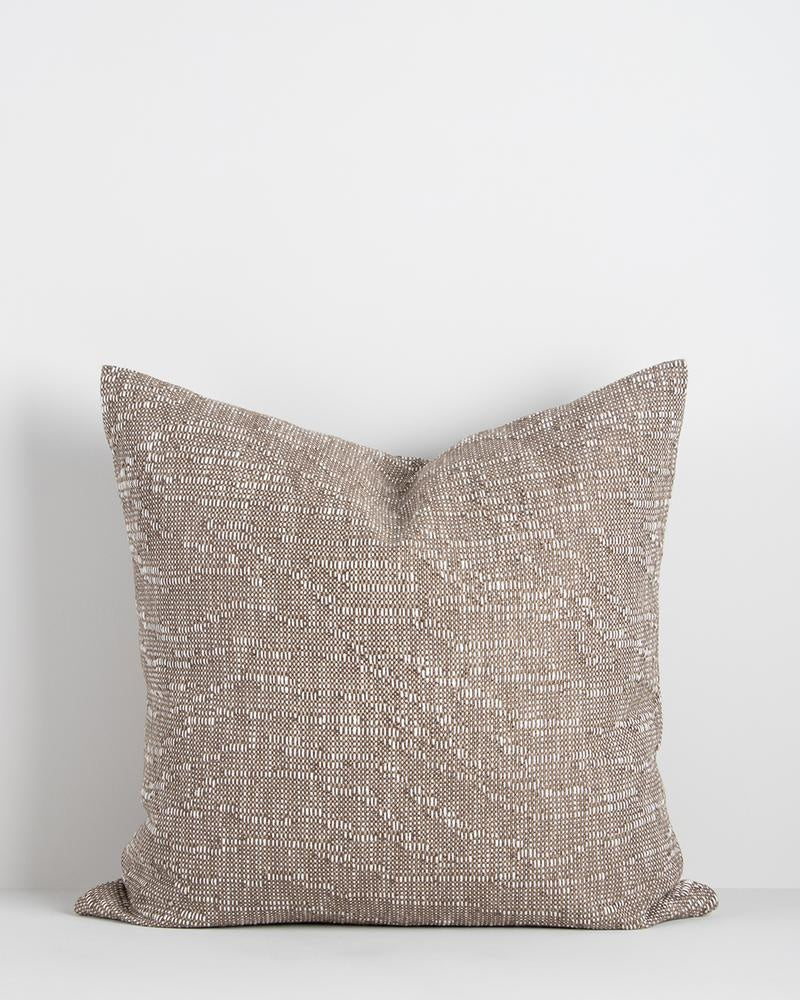 A coffee-brown cushion by Baya NZ, seen in full against a white background