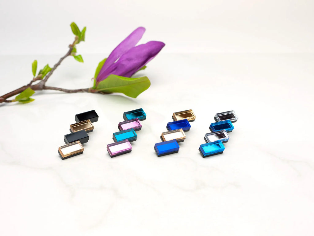 Four pairs of acrylic designer earrings by Mystic Forms