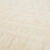 A creamy white wool-blend floor rug featuring an abstract horizontal pattern