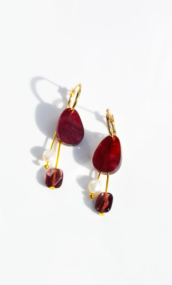 Maroon earrings with gold findings and a freshwater pearl charm 