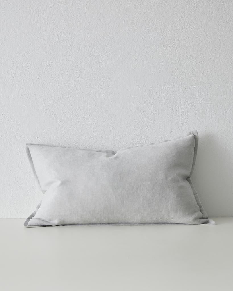 The Fiore lumbar cushion by Weave Home, in colour  'Glacier' - a pale blue-grey - with flange edge