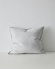 The Weave Home Fiore cushion in colour 'Glacier' - a pale blue-grey - with flange edge.