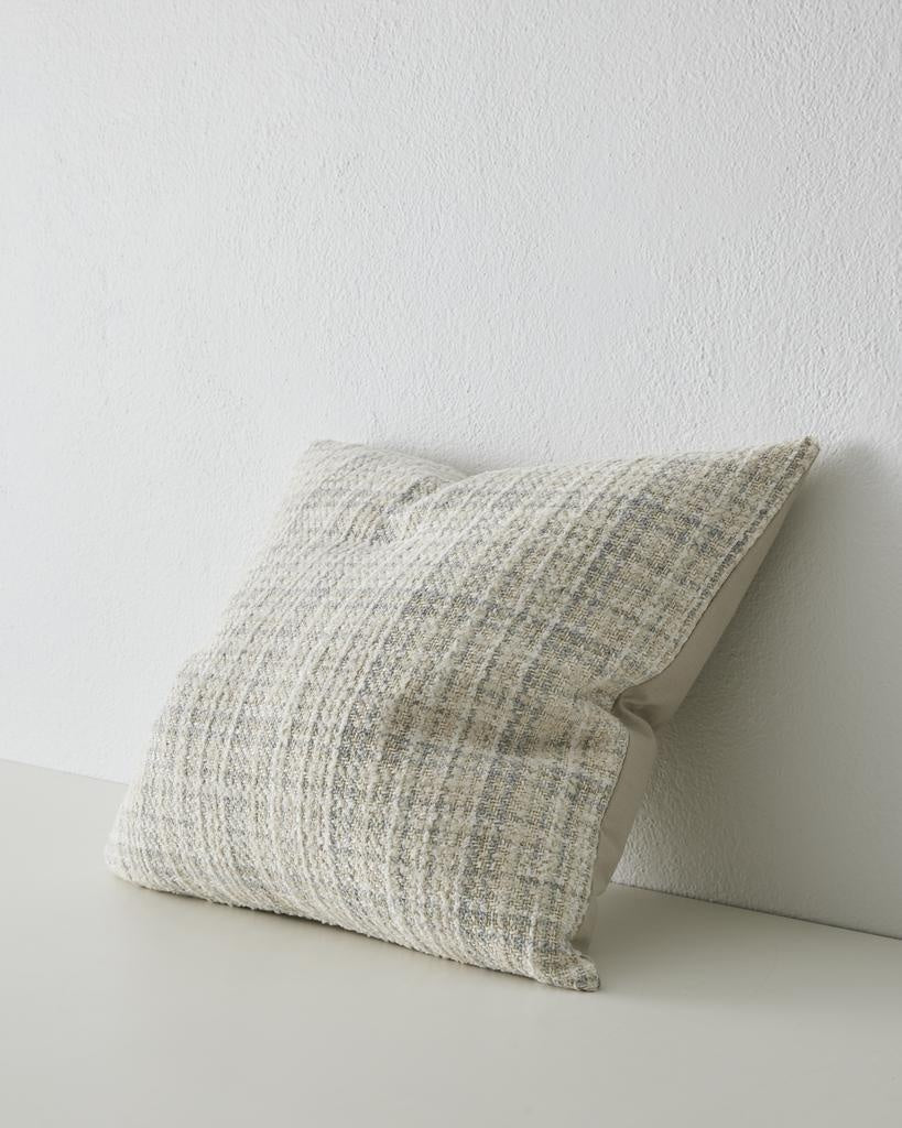 A beautiful woven cushion in white, alongside subtle beige and blue - the Tripoli Pearl seen in 3/4 perspective