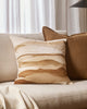 A printed cushion, patterned with gorgeous brown and tan abstract shapes reminiscent of sand dunes. By Baya. 