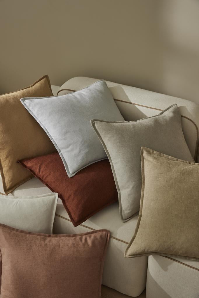 Multi-coloured Fiore high quality cushions by Weave Home NZ, scattered over a couch.