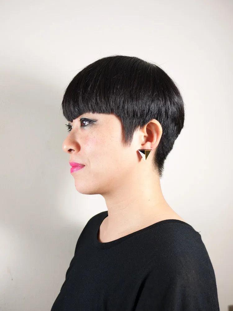 Model wearing gold, black and ivory triangular acrylic earrings by Mystic Forms