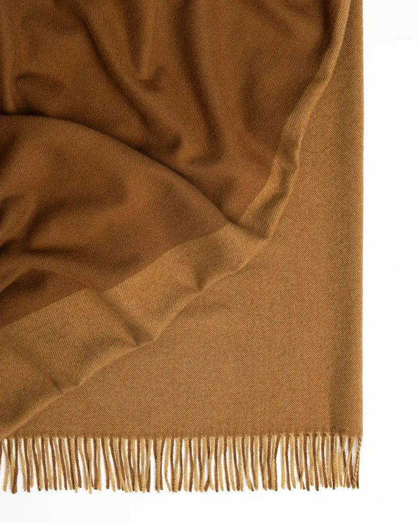 A two-toned caramel brown wool throw blanket by Weave NZ