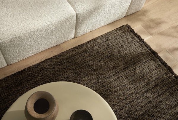 The 'Puglia' floor rug by Weave Home, in colour 'Pigeon" - a deep cool-toned brown, seen close up from above.