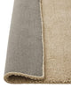 Close up of the Valencia Dune wool rug by Weave nz, with the edge folded up to reveal the backing.