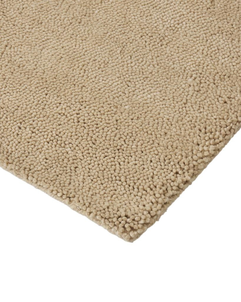 Close up of the Valencia Dune wool rug by Weave nz, showing it's milky beige colour and thick pile.