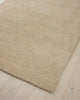 A pale, beige-brown 100% wool rug - the Valencia Dune by Weave, seen in perspective from above