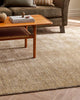 A stylish living room with a gorgeous handmade rug in shades of warm beige and soft ivory. By Baya