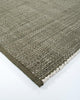 Close up corner view of the olive green Lonsdale outdoor rug by Baya, showing its edge detail and weave