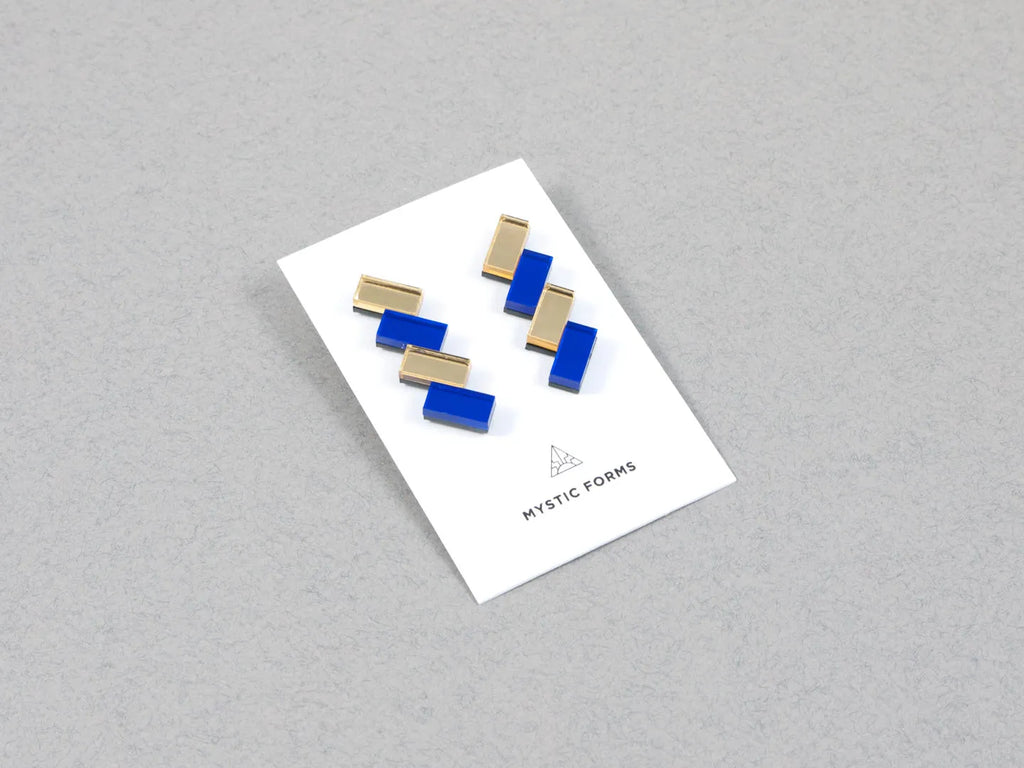 Blue and gold acrylic earrings on a card, by UK designer Mystic Forms