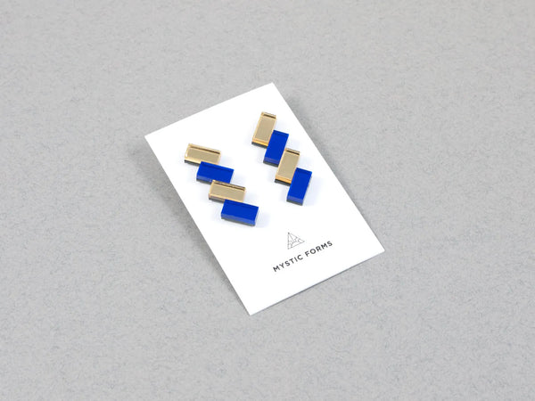 Blue and gold acrylic earrings on a card, by UK designer Mystic Forms