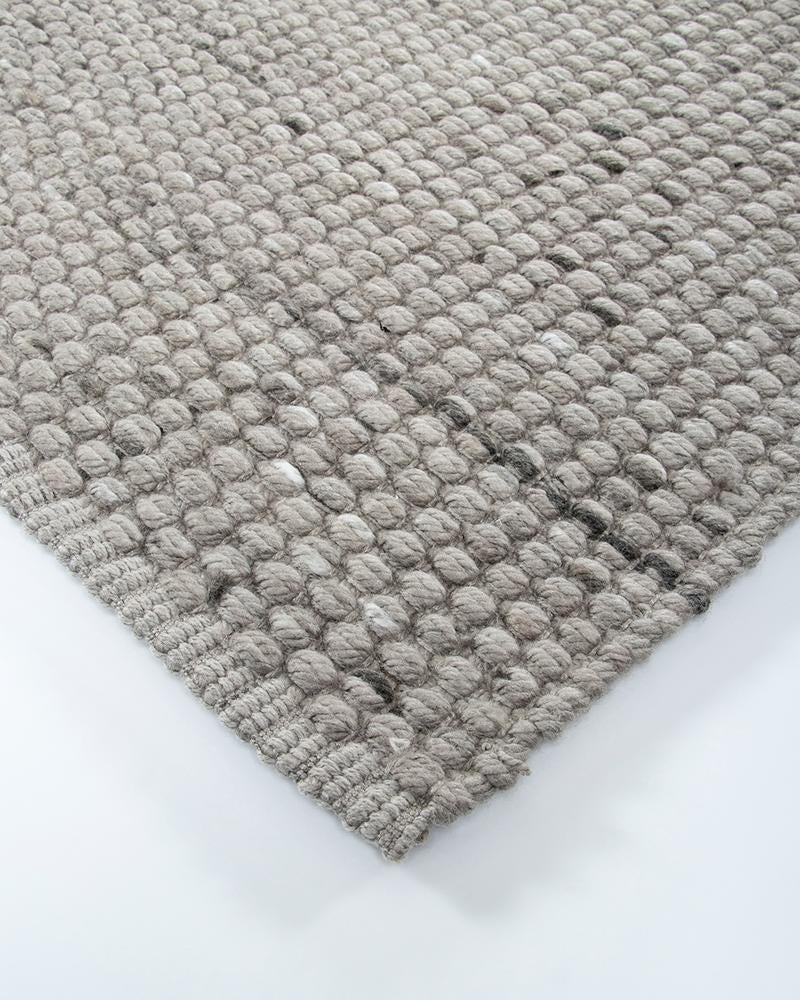 Close up corner view of the Baya Pelorus outdoor rug showing its textural weave