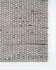 The Baya Pelorus grey outdoor rug by Baya seen close up on a corner showing the texture and edge detail