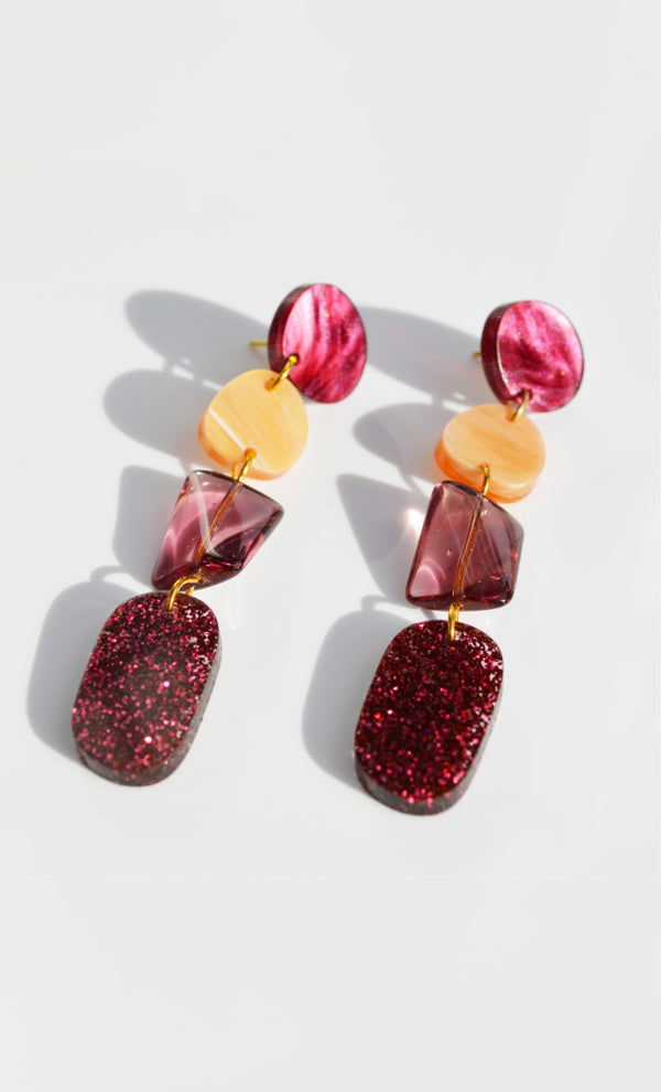 Beautiful dangle earrings by NZ designer Hagen + Co, featuring maroon and orange decorations