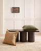A stylish living room with two cushions, both in textural linen, one deep green and one soft yellow brown. By Baya