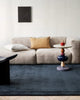 A cool toned living room with a statement deep midnight blue cut pile floor rug in 100% New Zealand wool. 