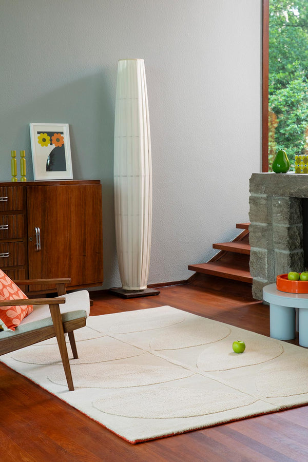 Orla Kiely designer floor rug 'Solid Stem Ecru' seen in a retro-styled modern living room