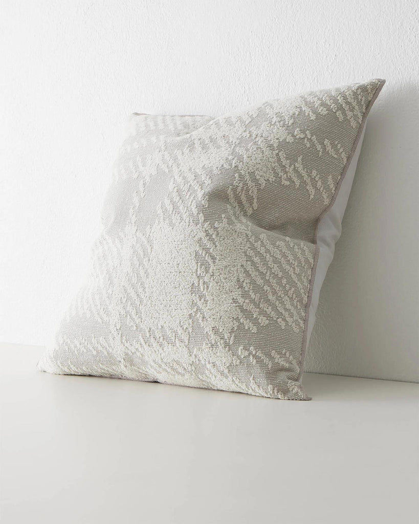 A side view of a textured pattern cushion in dove grey and cream. 
