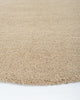 Close up edge of a light brown boucle weave wool floor rug - the Dorset Biscuit by Baya