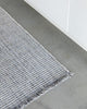 Close up of the slate grey Rhodes runner rug by Baya, seen on a kitchen floor