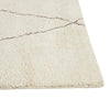 Corner of the plush pile of the wool Bower Linear rug with brown diamond detail