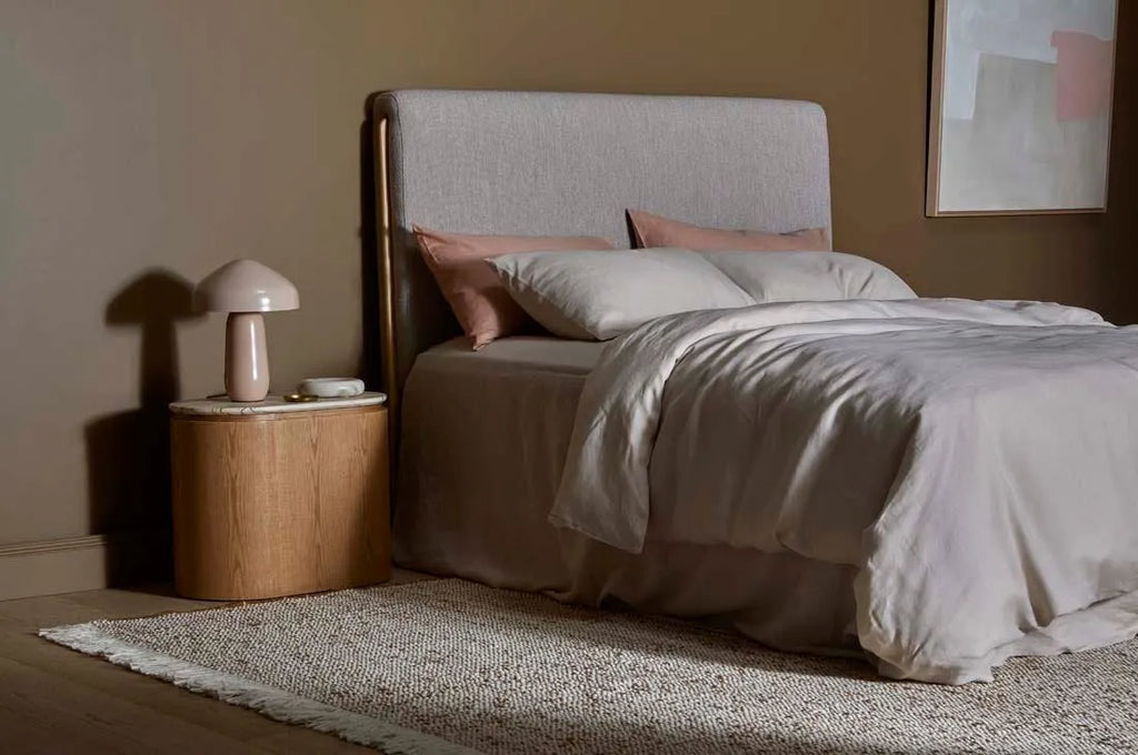 Large wool and jute blend floor rug in a cream and umber colour, in a stylish contemporary bedroom room