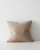 A softly textured light brown cushion. 
