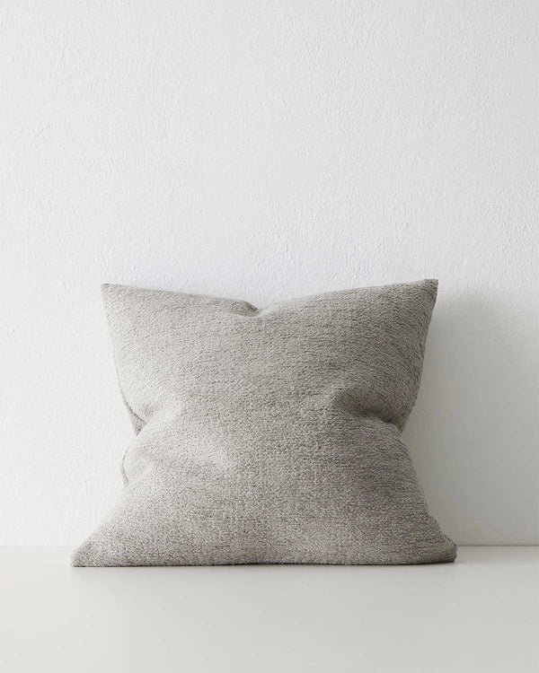 A soft textured slightly warm toned dove grey cushion. 