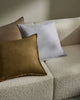 Three Fiore cushions in on-trend colours, by Weave Home, sitting on a cream boucle couch.