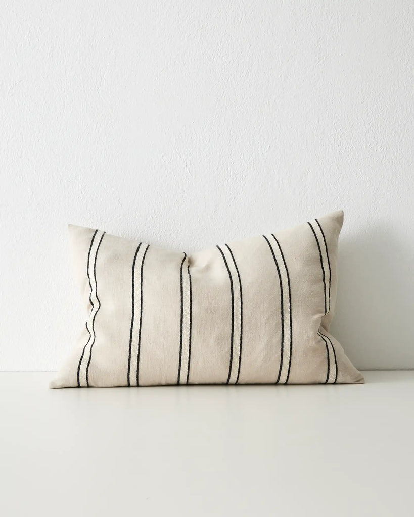 A classsic black, white and beige striped cushion. This is the lumbar style seen from the front