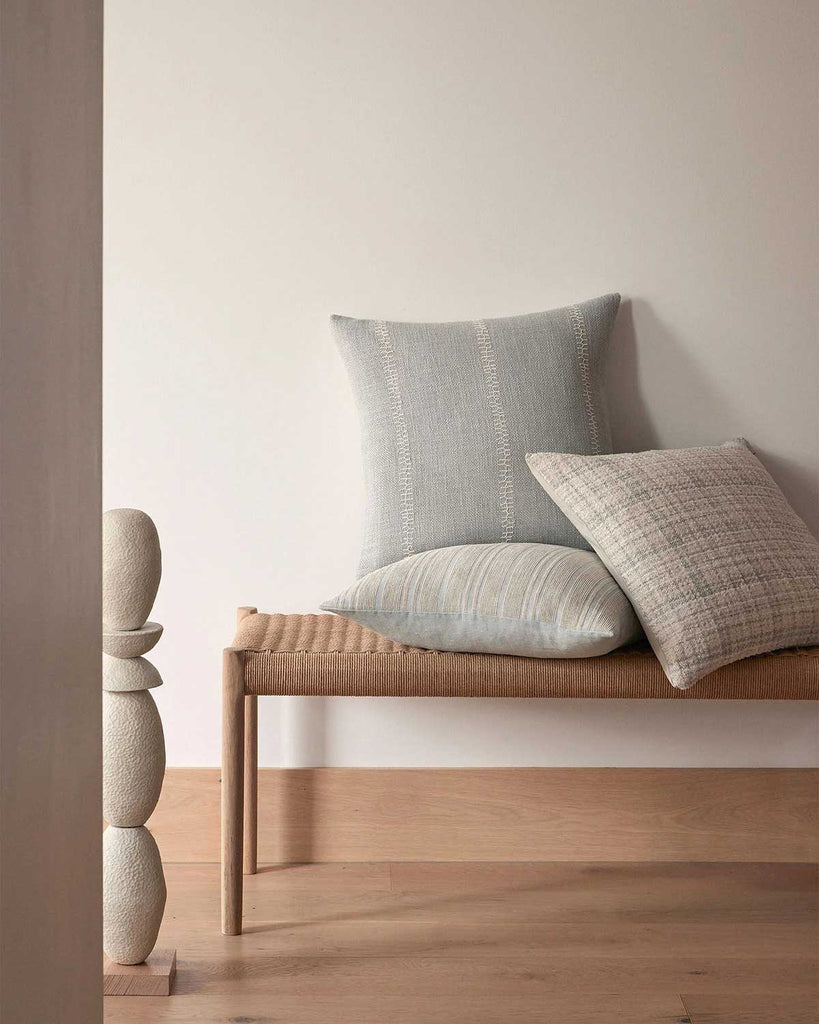 Soft blue and cream cushions on a benchseat in a stylish home