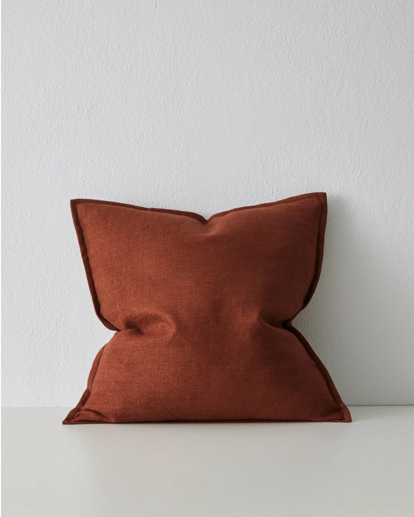 A redish maroon coloured cushion with flange, by Weave Home nz