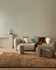 Home decor by Weave Home nz seen in a contemporary home -a wool floor rug, three plush cushions and a wool throw