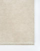 The Sandringham 'Merino' creamy white floor rug, close up showing the fringe detail and soft colour.