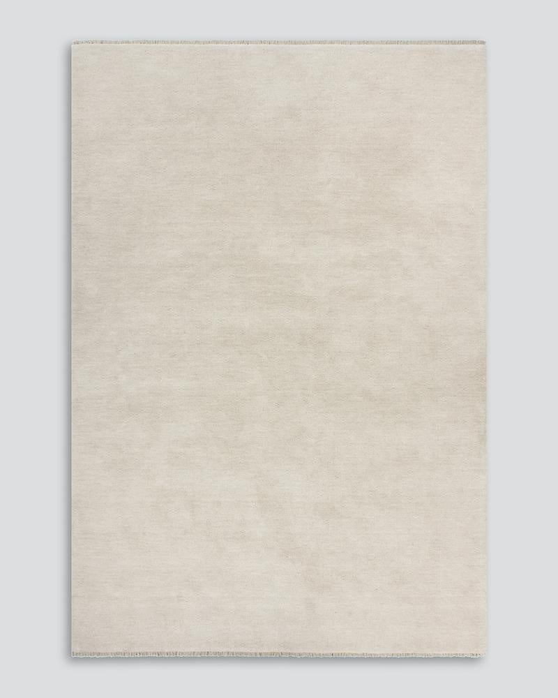 The Sandringham creamy white 'Merino' floor rug in pure wool, seen from above.