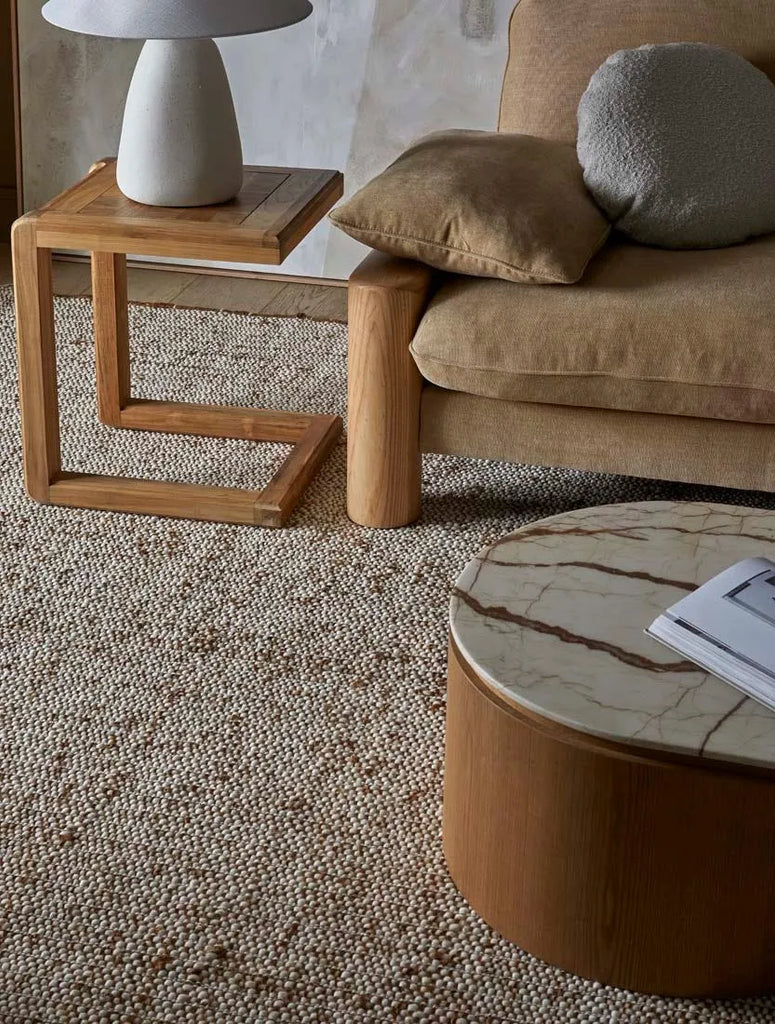 Large wool and jute blend floor rug in a cream and umber colour, in a stylish living room