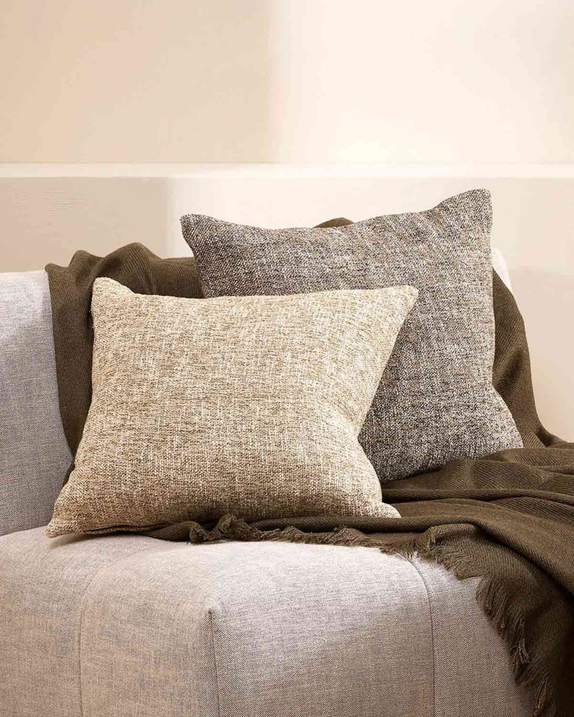 Two textured cushions in the Cumbria range by Baya. One in the shade Oak, one in the shade Pebble. The brown and cream texturality work brilliantly with the brown throw and cream armchair. 