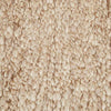 Close up of the weave of a textural wool blend boucle style rug by Globe West and Soren Liv NZ in shades of warm beige and light brown.