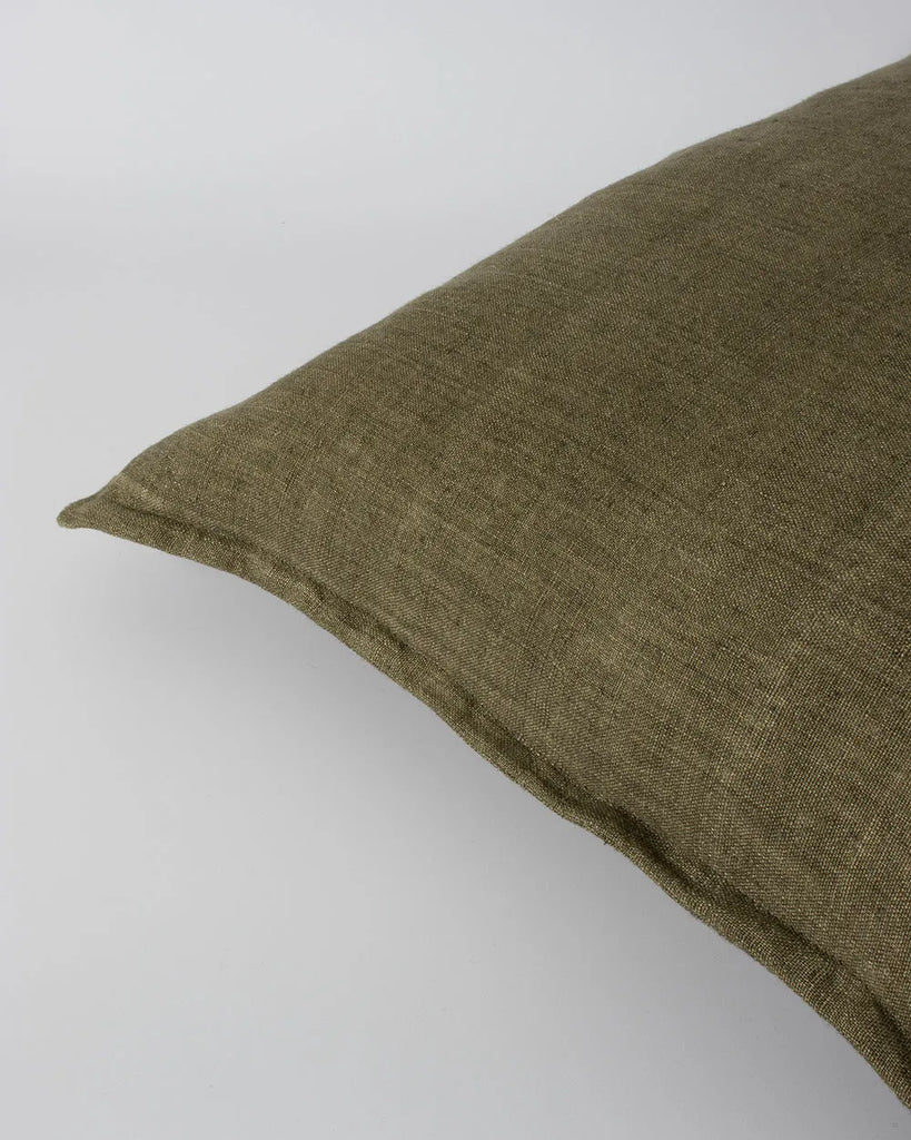 Close up of the Baya linen cushion, with flange edge detail, in colour military green