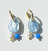 A set of gorgeous blue acrylic earrings with dangling charms made with freshwater pearls and vintage blue beads. 