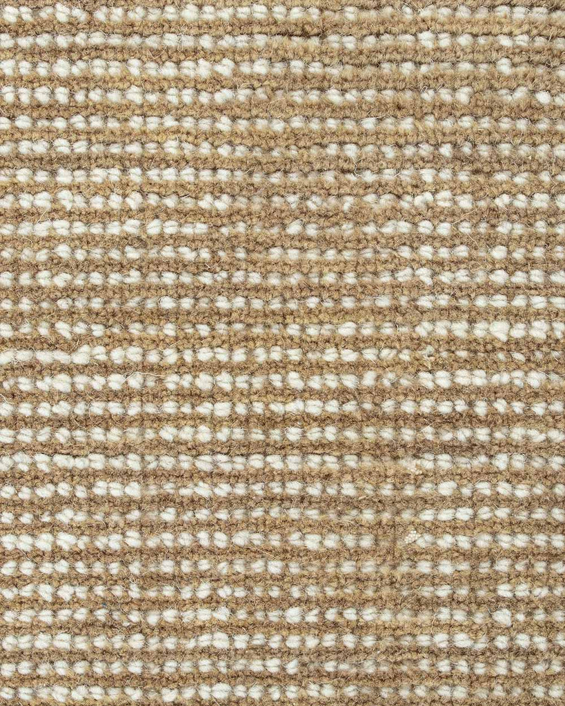 A close up image of a handloomed warm beige and cream toned floor rug in 100% New Zealand Wool by Baya