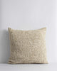 A textural woven cushion in shades of creamy oat and ercu, by Baya